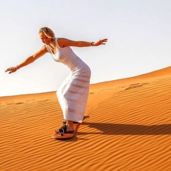 Women Sand Boarding in Desert